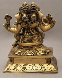 Back view brass two-headed Ganesha statue, raised arms and decorative base