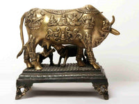 Bronze-gold cow and calf statue on dark base, carved figures on body, 15 in