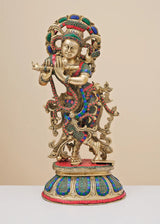 Brass Krishna flute sculpture with colorful inlay, detailed crown and ornaments