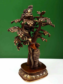 Natural brass Krishna figure above Radha beneath detailed tree, brown base, 12.5 cm