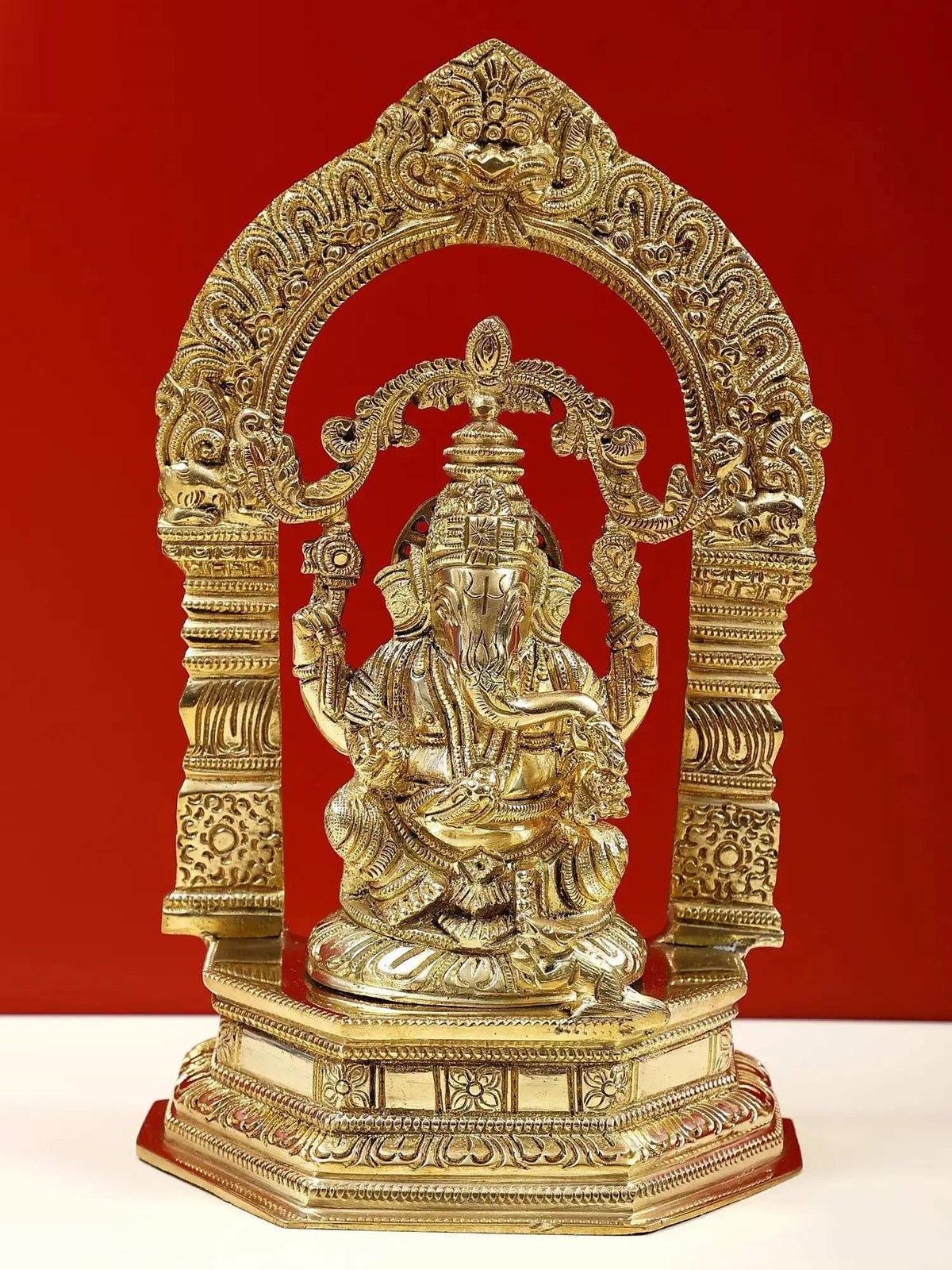 Brass Lord Ganesha idol with kirtimukha arch on pedestal, 9-inch