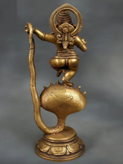 Brass dancing Lord Ganesha statue, seated on Sheshnaag serpent hood, textured belly