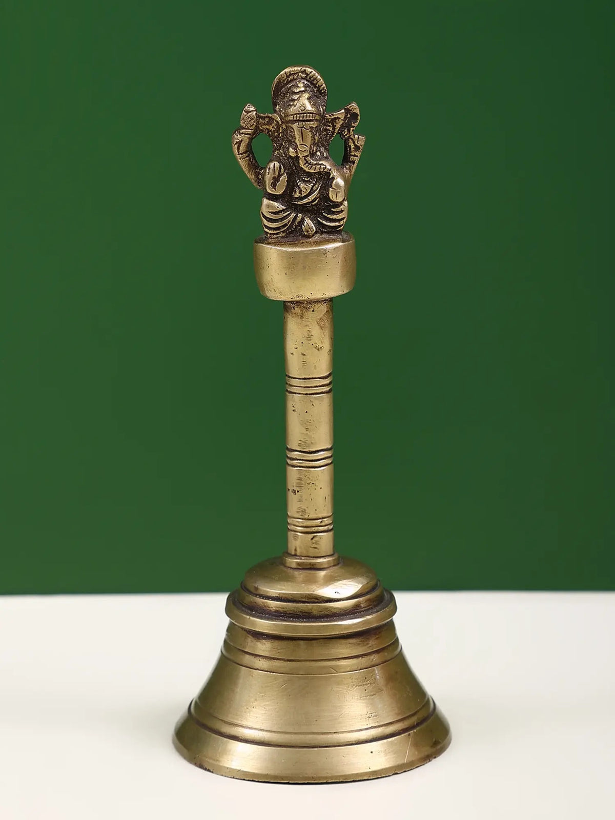 7-inch handheld brass bell with Ganesha figure on top, decorative base