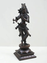 Standing Lord Krishna brass-look statue playing flute, side view, ornate costume and pedestal base