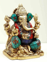 Brass seated Ganesh idol with raised arms, turquoise and red patterned inlays, 6 in