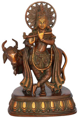 Handcrafted brass Krishna statue with cow, 10 inch, halo and flute pose