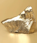 Natural brass Ganesha temple idol, textured rock-like surface from the side