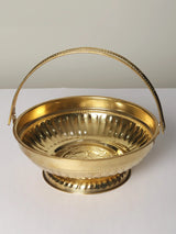 Brass pooja basket with fluted rim, scalloped pedestal base, and ridged bowl sides.