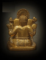 Back view of small brass Ganesha sculpture, seated posture with stacked arms