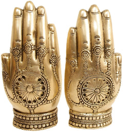 Brass hands with decorative palm engravings, round motifs and patterned cuffs, pair