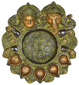 Brass diya plate with Lakshmi and Ganesha relief, ornate oil-cup edge