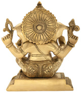 Handmade brass Ganesha statue, rear view with ornate halo details, seated, 7 inch