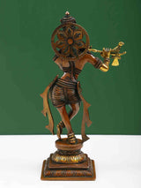 Brass Lord Krishna statue with decorative back halo, holding flute and arm raised