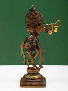 Brass Lord Krishna statue with decorative back halo, holding flute and arm raised