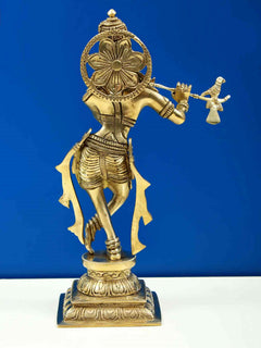 Lord Krishna brass flute statue with decorative wheel motif, 12 in height