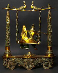 Greenish gold brass peacock swing statue, Radha Krishna seated on brass platform