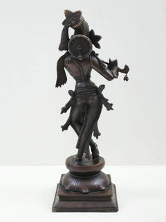 Brass-look Lord Krishna statue standing with flute, back/side view, detailed jewelry and pedestal base
