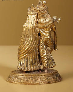 Gold brass Radha Krishna statue side view, flowing robes, ornate crowns, pedestal base