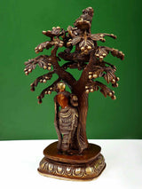 Brown and natural brass tree sculpture with Krishna and Radha standing beneath, 12.5 cm