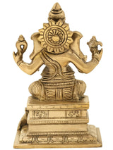 Brass Ganesha statue, ornate halo and crown, seated on pedestal, 6 inch