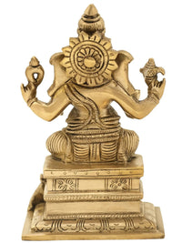 Brass Ganesha statue, ornate halo and crown, seated on pedestal, 6 inch