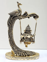 Brass Ganesha swing ornament with peacock backrest and detailed engraved frame
