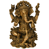 Brass Ganesha statue seated on a lotus with four raised arms