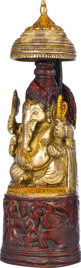 Ganesha figurine with gold detailing and red patterned pedestal, 10-inch