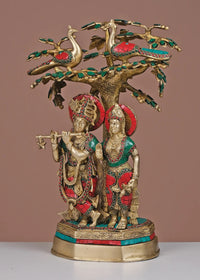 Brass Radha-Krishna idol under ornate tree with green and red inlay, 19-inch