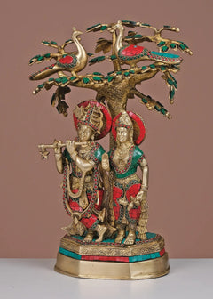 Brass Radha-Krishna idol under ornate tree with green and red inlay, 19-inch