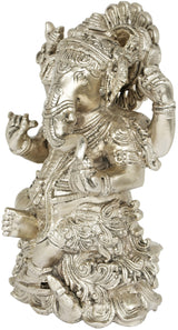 Ganesha brass-silver figurine, side view, seated on lotus with ornate arms