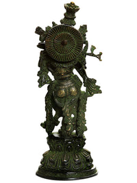Handmade brass Krishna statue from back, arched wheel and ornate backplate, dark green.