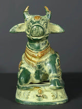 Front view Nandi brass statue with raised horns, fan-like ears, and engraved collar