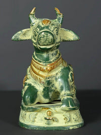 Front view Nandi brass statue with raised horns, fan-like ears, and engraved collar