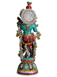 Silver-hued Krishna statue from behind, fluted details and crown back disc
