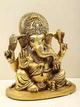 Brass Ganesha figurine, profile view, ornate crown, raised blessing hand, 6 inch
