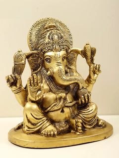 Brass Ganesha figurine, profile view, ornate crown, raised blessing hand, 6 inch