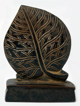Brass Lord Shiva head on leaf statue, back view with leaf vein details.