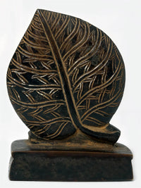 Brass Lord Shiva head on leaf statue, back view with leaf vein details.