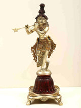Brass Lord Krishna statue with flute, on dark red pedestal base, 12 inch