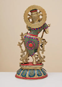 Rear view of brass Krishna flute sculpture with patterned inlay and ornate back