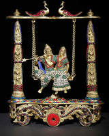 Brass Radha-Krishna swing statue with jeweled inlay, ornate base, twin hanging chains