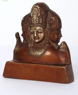 Small brass Trimurti statue side view with detailed crown and halo