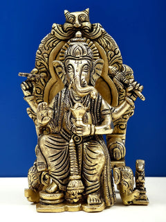 Brass 6-inch Ganesha sculpture, enthroned with ornate crown and halo