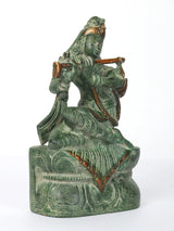 Krishna flute-playing idol seated on pedestal, profile view, green patina, 7-inch