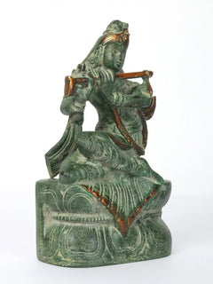 Krishna flute-playing idol seated on pedestal, profile view, green patina, 7-inch