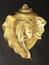 Brass Ganesha wall mask with detailed gold-toned headpiece and side profile relief