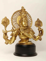 Natural brass Krishna bust with ornate halo and bow, on black base