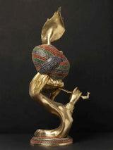 Brass Krishna statue side view, jeweled draped torso, hands holding flute