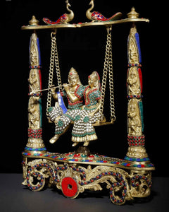 Brass Radha-Krishna swing statue with colorful inlay on pedestal pillars and chain swings
